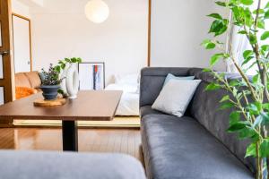 a living room with a couch and a table at サンヒルズマンション in Tosu +27 photos