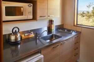 a kitchen with a sink and a microwave at Glentanner Park Centre in Glentanner