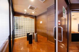 a room with a door and a wall of wood at Hirosaki Plaza Hotel in Hirosaki