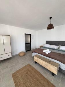 a bedroom with a large bed and a dresser at LA SIESTA Suites in Huarmey +19 photos
