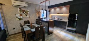 a kitchen and dining room with a table and chairs at Cabañas MI REFUGIO TERMAL in Roboré
