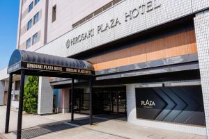 a building with a sign in front of it at Hirosaki Plaza Hotel in Hirosaki