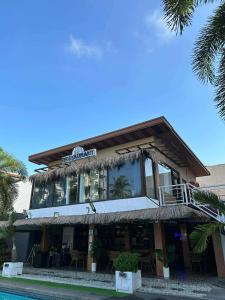 a building with a restaurant on top of it at At The Pad Hotel & Villa's in Angeles