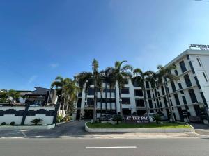 an apartment building with a sign in front of it at At The Pad Hotel & Villa's in Angeles +3 photos