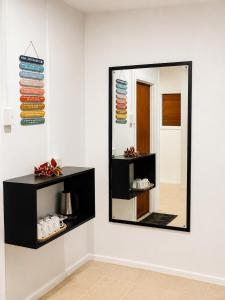 a mirror on a wall in a room at Crusoe's Retreat - Family Friendly in Namanggumanggua