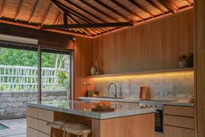 a kitchen with a sink and a counter top at Sejati Boutique Hotel Uluwatu in Uluwatu