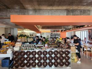 a group of people standing around a food store at Jh 블라썸 캡슐 앤 케빈 호텔 in Busan