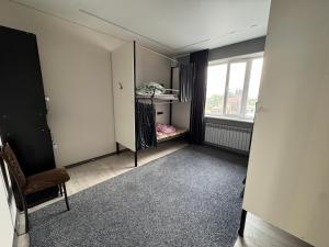 an empty room with a mirror and a window at Hostel in Talas