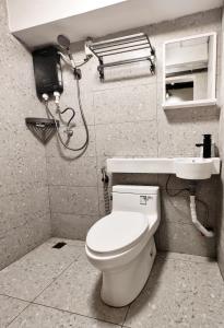 a bathroom with a toilet and a shower at Wood Wood Hostel in Vientiane