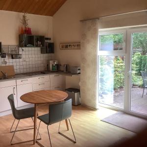 a kitchen with a table and chairs and a window at Landleben - Ferienhaus 1 in Fritzlar