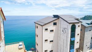 a building with a view of the water at Samcheok Laon Spa Pension in Samcheok
