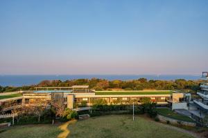 an aerial view of a building with the ocean in the background at Ocean Vista Pebble Beach in Umhlanga