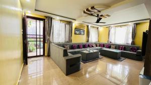 a living room with a couch and a table at Borrow and Pay in Heṭauḍā