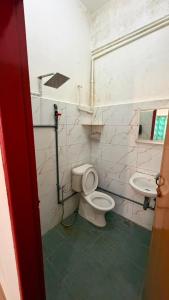 a bathroom with a toilet and a sink at Hotel CY in Sungai Besar