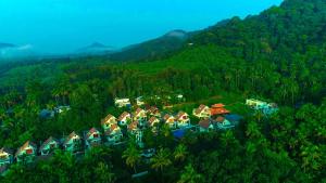 a group of houses in the middle of a mountain at Villas NEST Athirappilly in Athirappilly