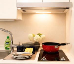 a kitchen counter with a pot on a stove top at November Myeongdong in Seoul +49 photos