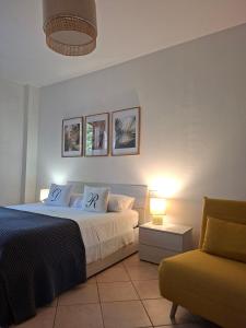 a bedroom with a bed and a chair and a lamp at Dream Room Apartment in Illasi
