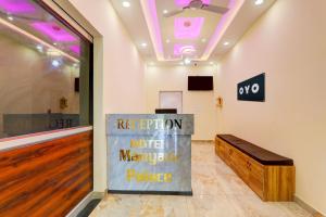 a room with a sign on the wall and a bench at Hotel manyam palace in Gorakhpur