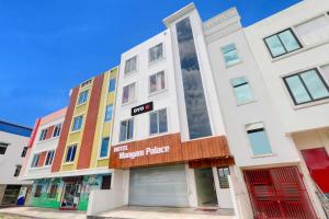 an apartment building with colorful windows on a street at Hotel manyam palace in Gorakhpur