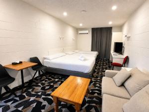 a hotel room with a bed and a couch at Pathfinder Motel in Melbourne +16 photos