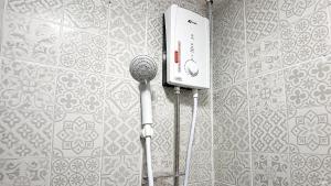 a bathroom with two microphones on a wall at Destiny Hostel Pattaya in Jomtien Beach