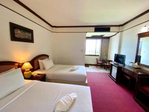 a hotel room with two beds and a television at Crystal Hotel Krabi in Krabi +21 photos