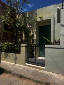 a house with a black door and a fence at Bernardino in Valladolid +2 photos