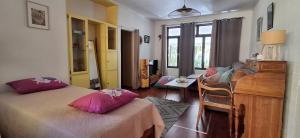 a bedroom with two beds and a desk in it at SCO Lodge in Punaauia
