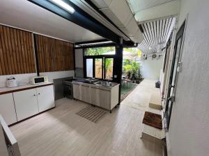 a kitchen with a stove and a sink in a room at SCO Lodge in Punaauia
