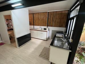 a kitchen with a sink and a counter top at SCO Lodge in Punaauia +33 photos