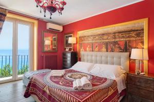 a bedroom with a large painting on the wall at Villa Fuenti Bay - Amalfi Coast in Cetara