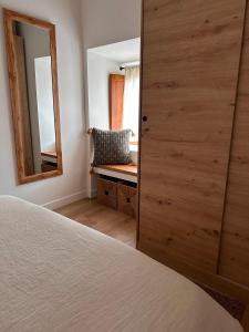 a bedroom with a bed and a mirror at Erreka Etxea in Murueta-Orozko