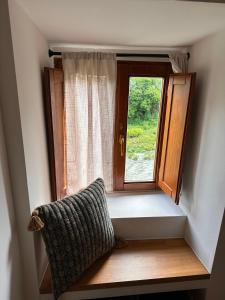 a window in a room with a pillow in front of it at Erreka Etxea in Murueta-Orozko
