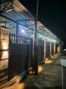 a fence in front of a building at night at На Желтоксан in Taldykorgan