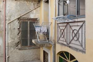 a building with a window and a clothes rack on a balcony at Tre Corone - Sarno in Sarno +11 photos