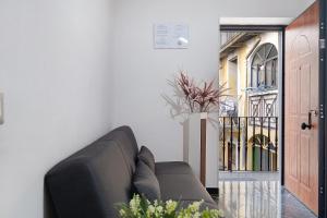 a living room with a couch next to a door at Tre Corone - Sarno in Sarno