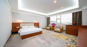 a hotel room with a bed and a desk and chair at Bashan Hotel in Xiamen +276 photos
