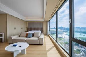 a living room with a bed and a couch and a table at 栖雅民宿 in Beijing