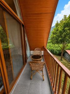 a balcony with a table and a chair on it at Sukute River Hub Beach Resort in Dolālghāt