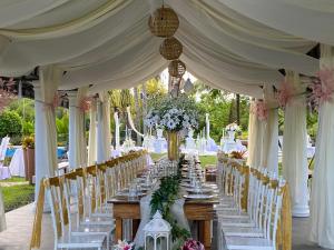 a long table set up for a wedding with white chairs at Churinga Eco Resort in Tigaon