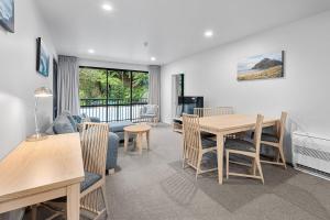 a living room with a table and chairs and a couch at Quality Hotel Oceans Tutukaka in Tutukaka