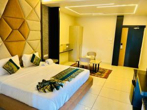 a bedroom with a large bed in a room at The Hotel Emerald in Koraput
