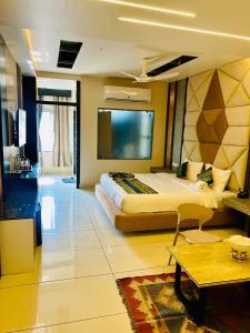 a large hotel room with a large bed in it at The Hotel Emerald in Koraput