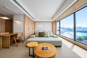a bedroom with a bed and a table and a desk at 栖雅民宿 in Beijing