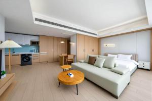 a living room with a couch and a kitchen at 栖雅民宿 in Beijing