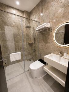 a bathroom with a shower and a toilet and a sink at Hotel Gia Hưng in Bảo Lộc