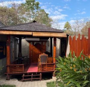 a pavilion with a chair on a wooden deck at Tentrem Bungalow in Labuan Bajo