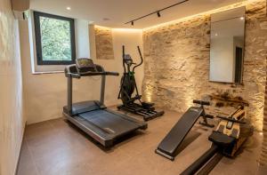 a gym with two tread machines and a mirror at Hôtel Mercure Villeneuve sur Lot Moulin de Madame in Villeneuve-sur-Lot