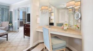 a bathroom with a large vanity with a mirror at The Windsor Court in New Orleans +125 photos