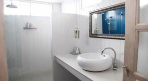 a white bathroom with a sink and a mirror at Baan Hmon-Oon in Chiang Mai +216 photos